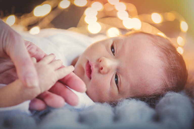 iStock 903107826 baby under fairy lights 768x512